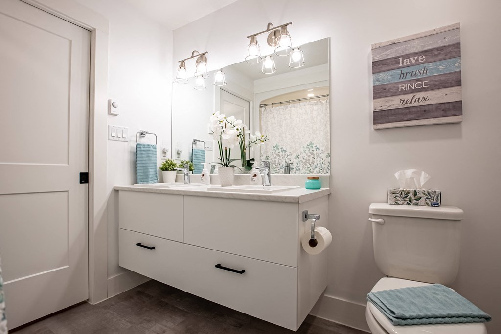 a bathroom with a toilet and a sink and a mirror