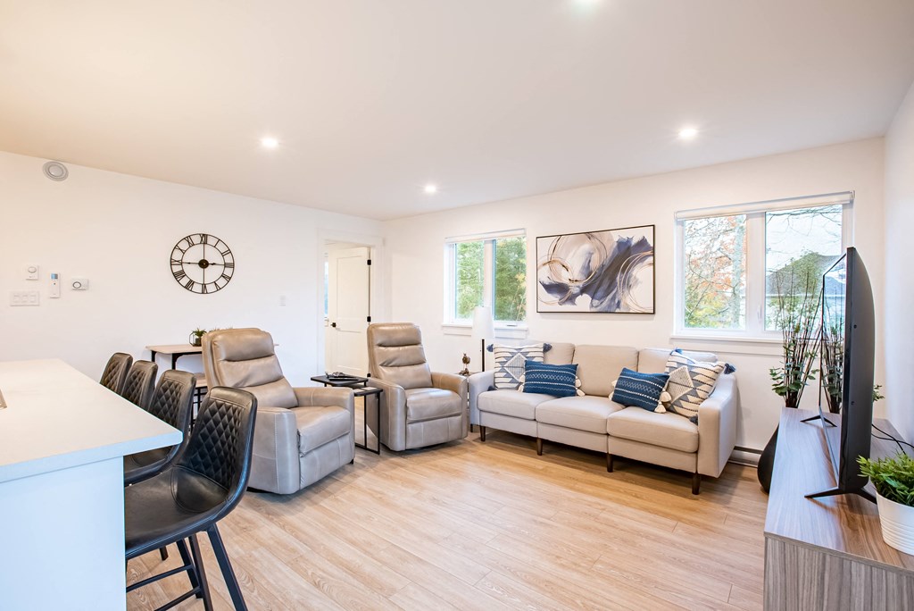 a living room with couches and chairs and a dining table