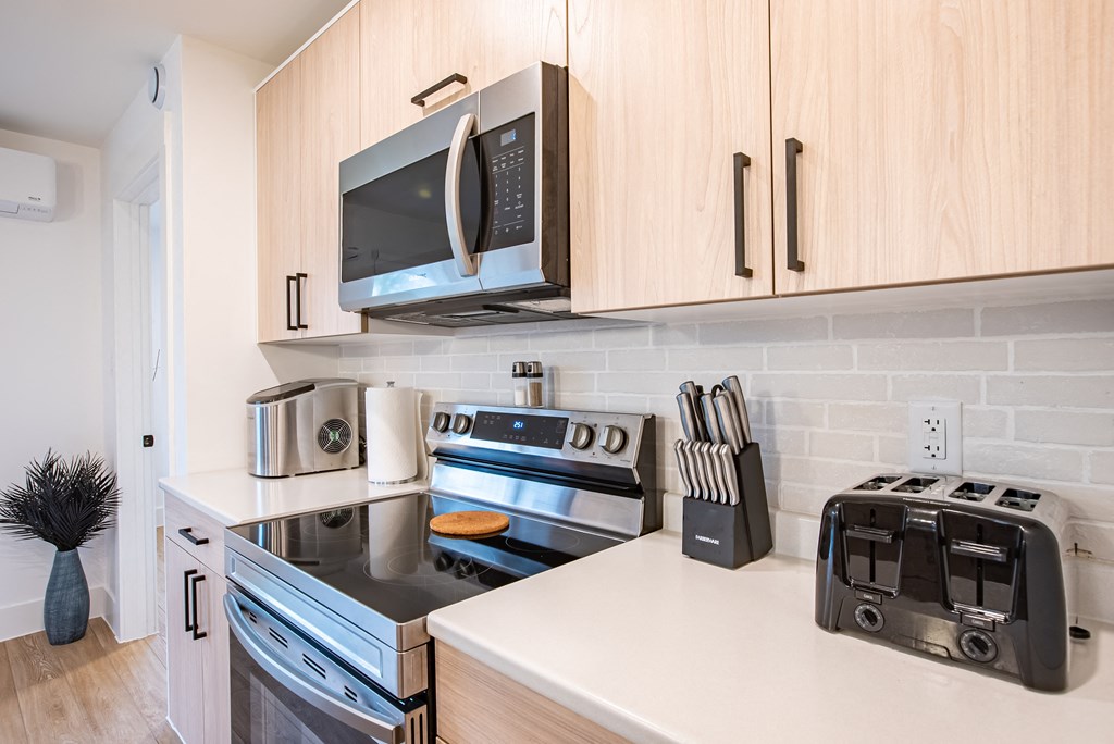 a kitchen with stainless steel appliances and a microwave