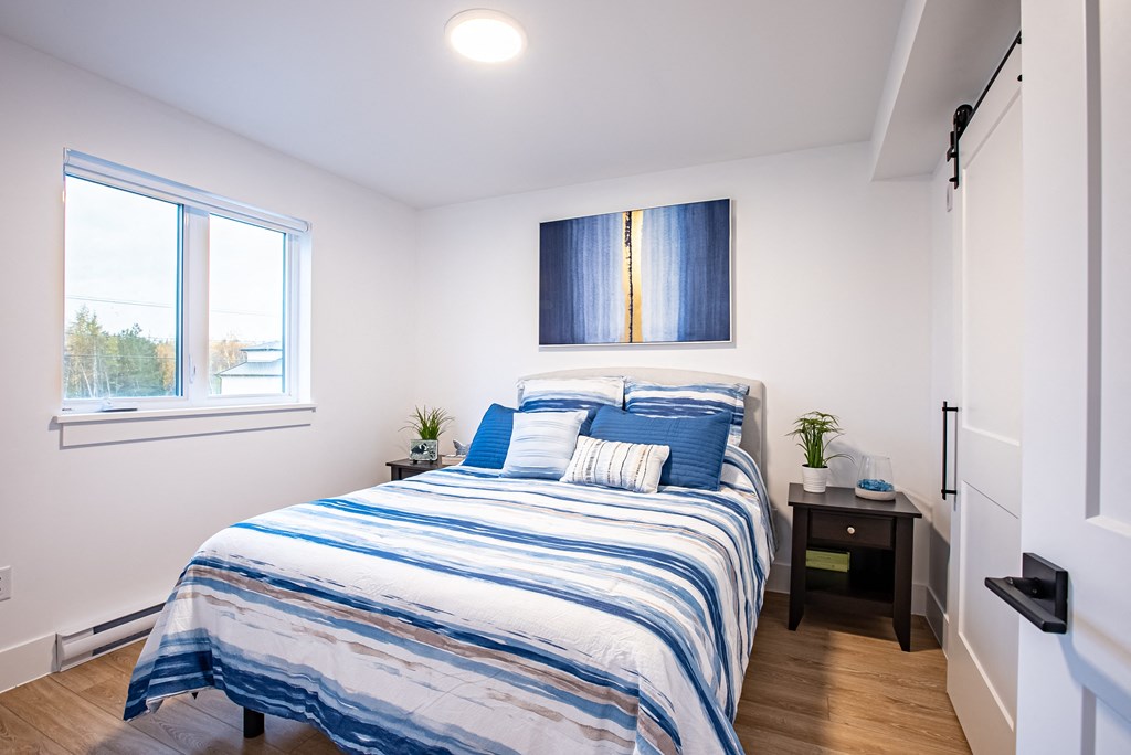 a bedroom with a bed and a window