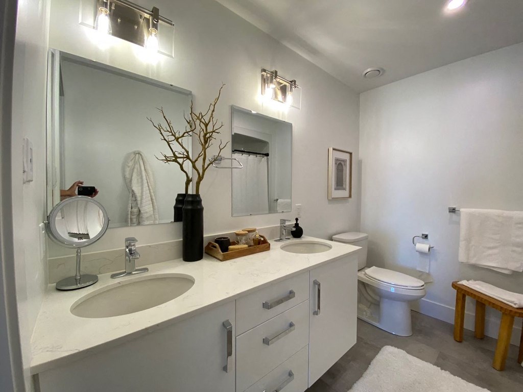 a bathroom with two sinks and a toilet