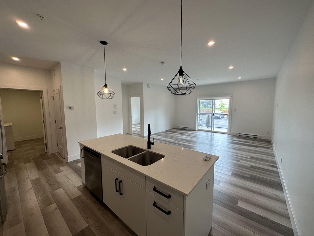 a kitchen and living room in a new home