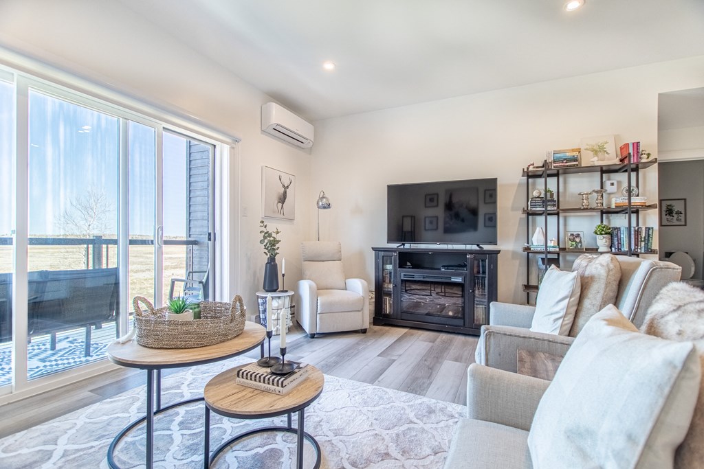 a living room with a couch and a chair and a television