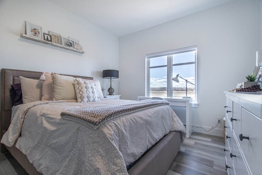 a bedroom with a bed and a window