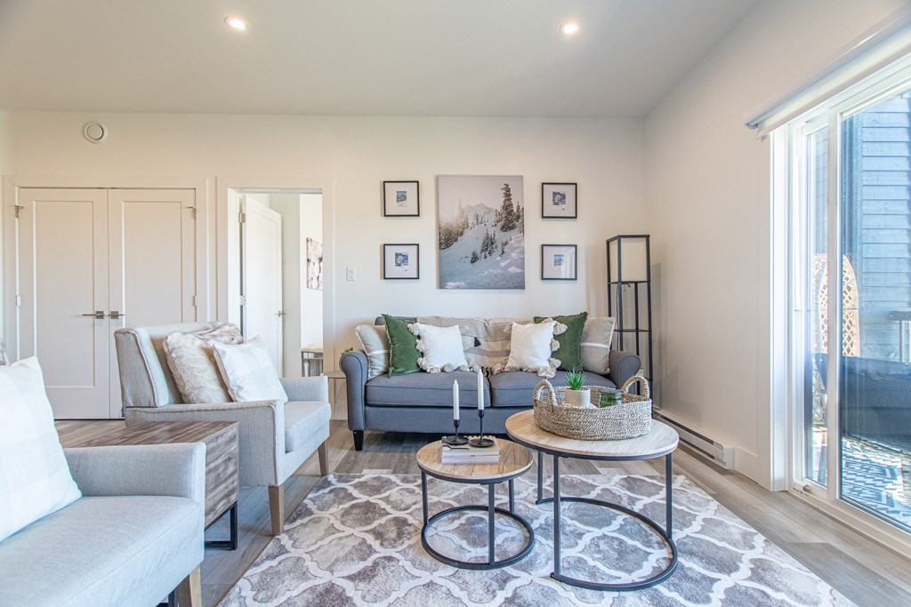 a living room with couches and chairs and a table
