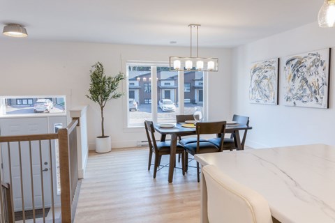 A dining room with a table set for four.