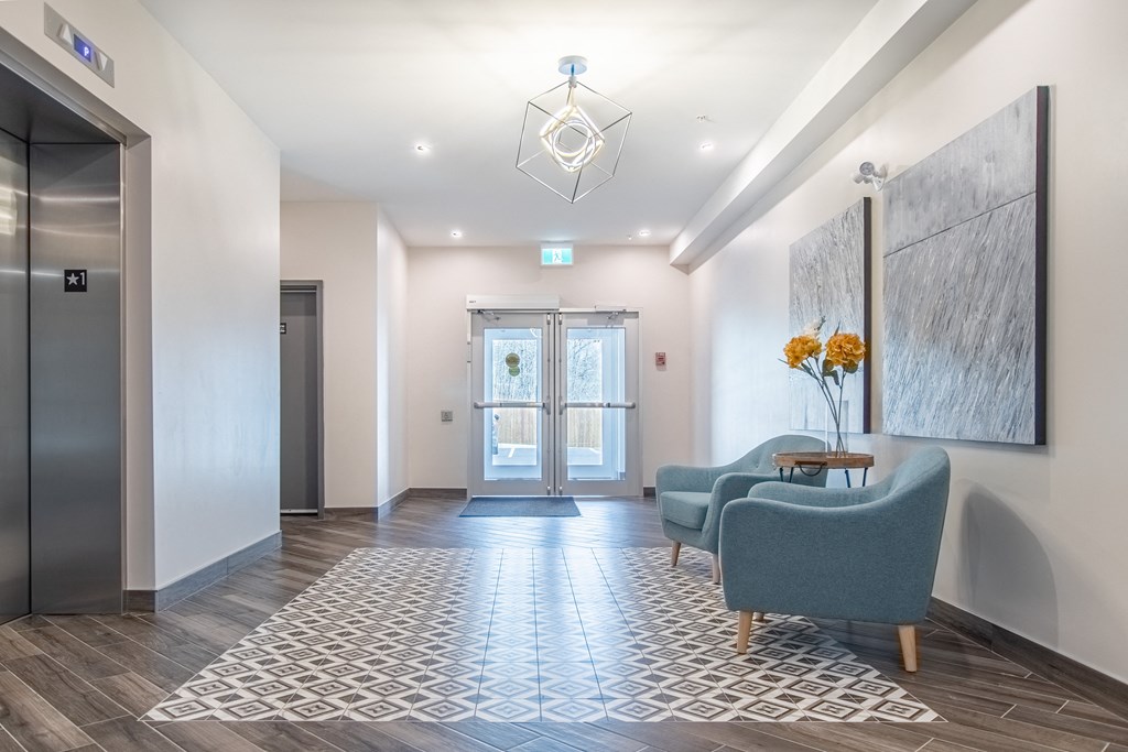 a lobby with couches and chairs and a door