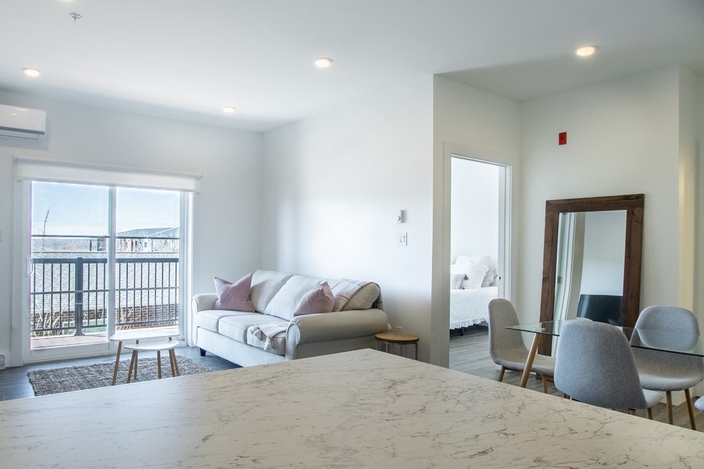 a living room with a kitchen and a couch and a table