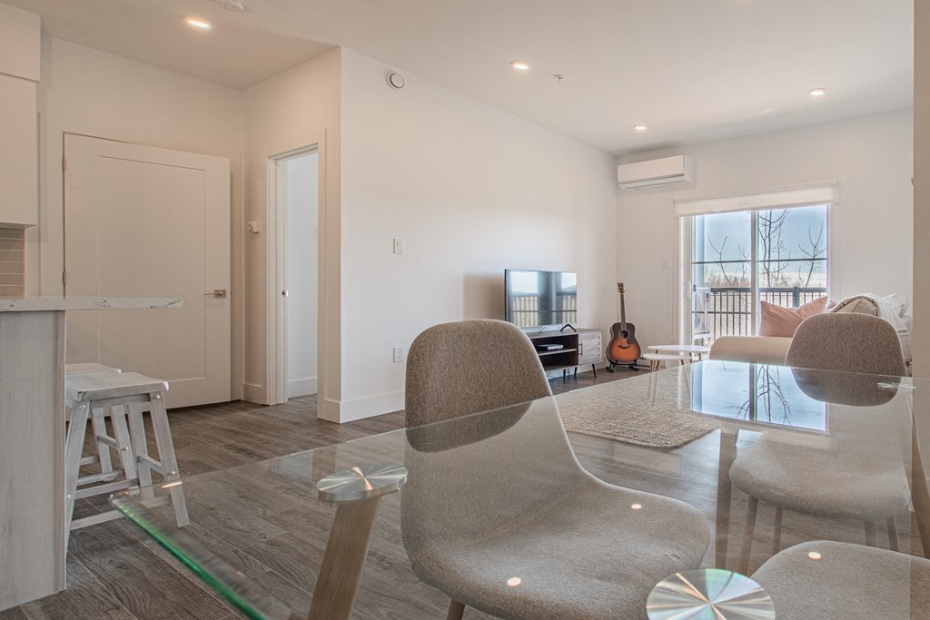 a living room with a couch and chairs and a glass table