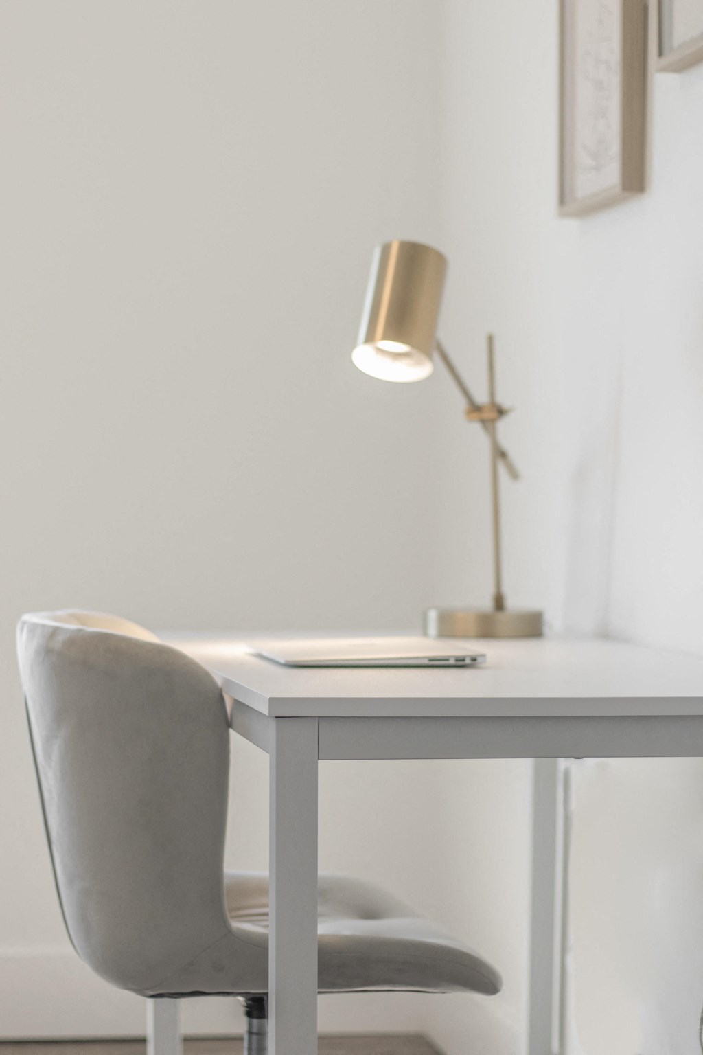a desk with a chair and a lamp in a room