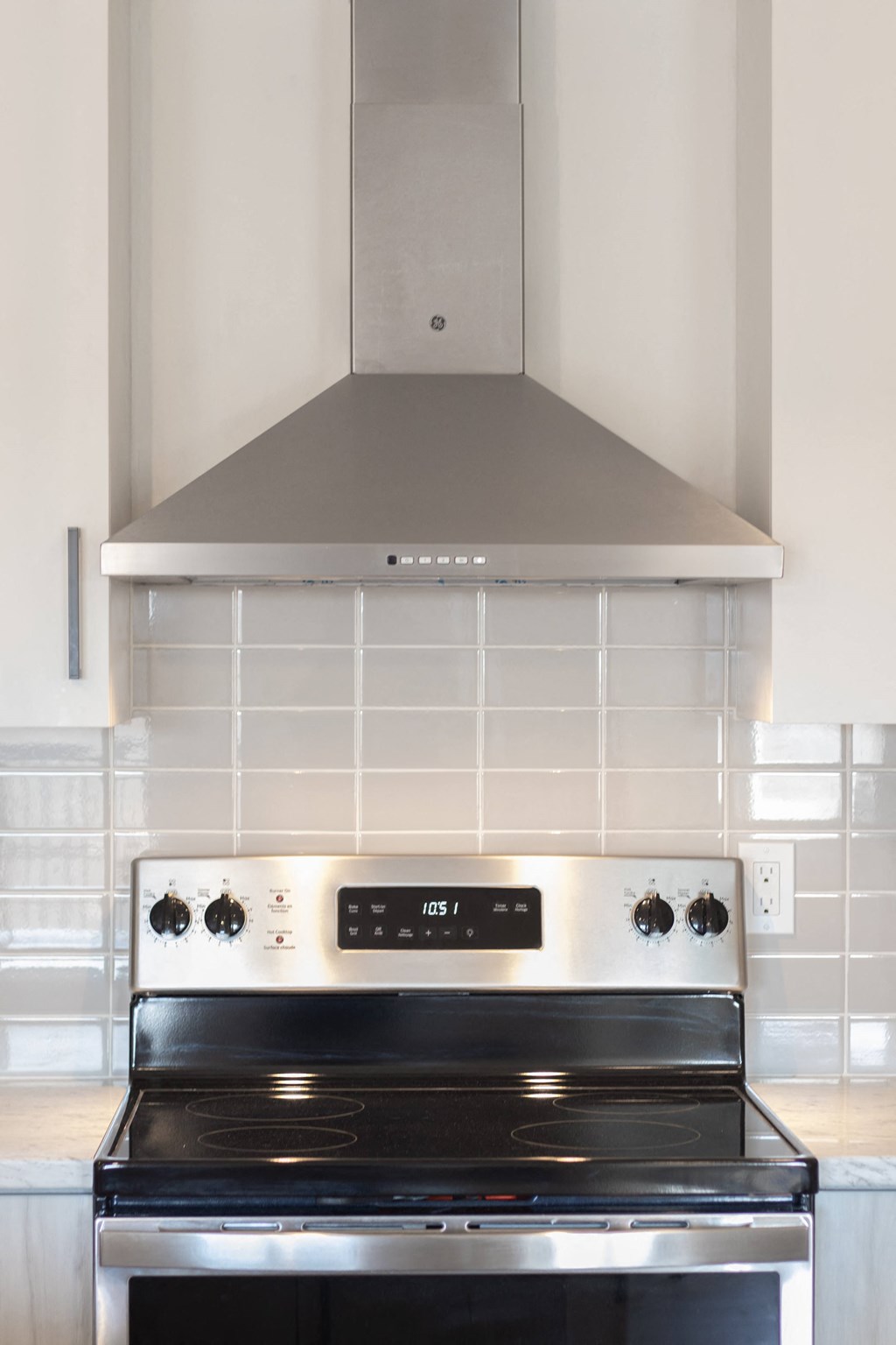 a small kitchen with a stove and a hood