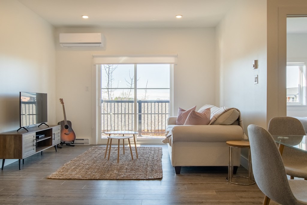 a living room with a couch and a chair and a television