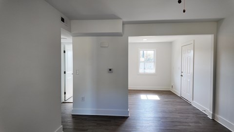 A room with white walls and a window.