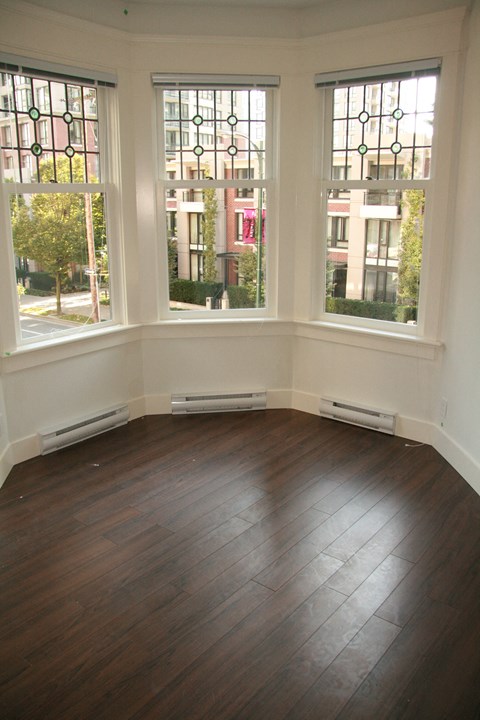 A room with a window overlooking a street.
