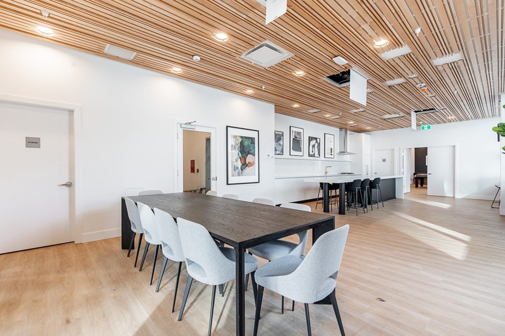 a conference room with a long wooden table and chairs