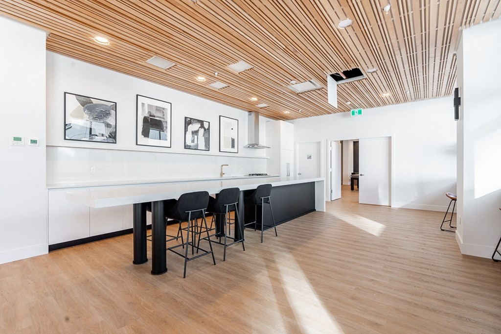 a conference room with a long table and black chairs