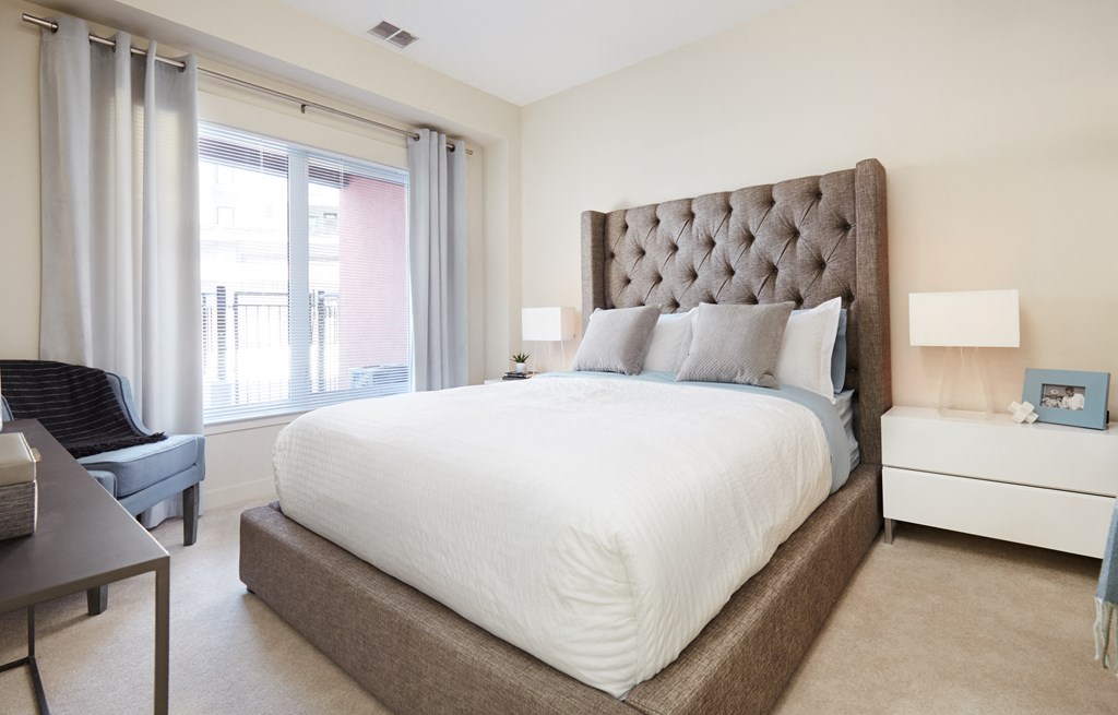 a bedroom with a large bed and a window