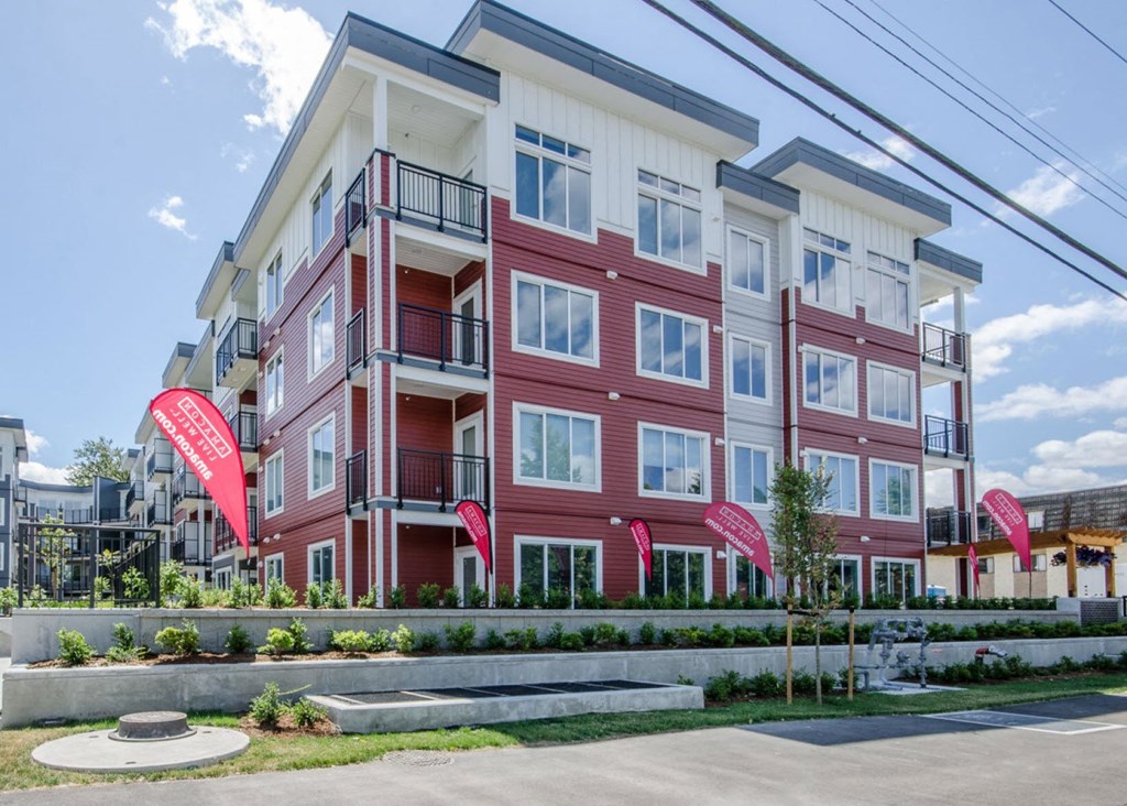 a building with red flags in front of it