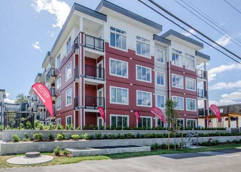 a building with red flags in front of it