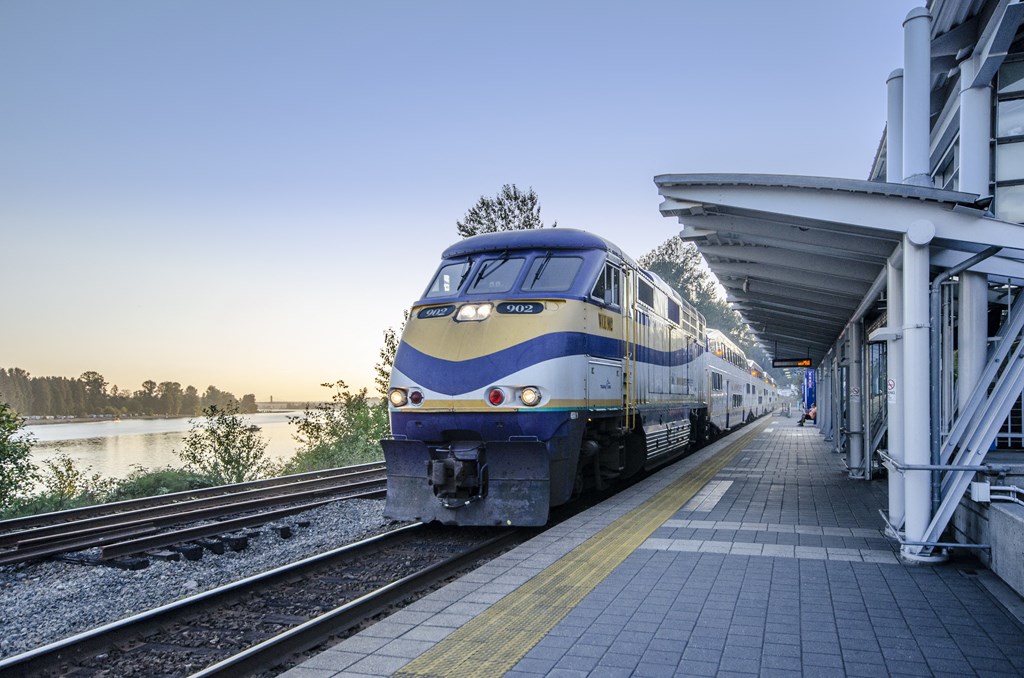 a train pulling into a train station next to a platform