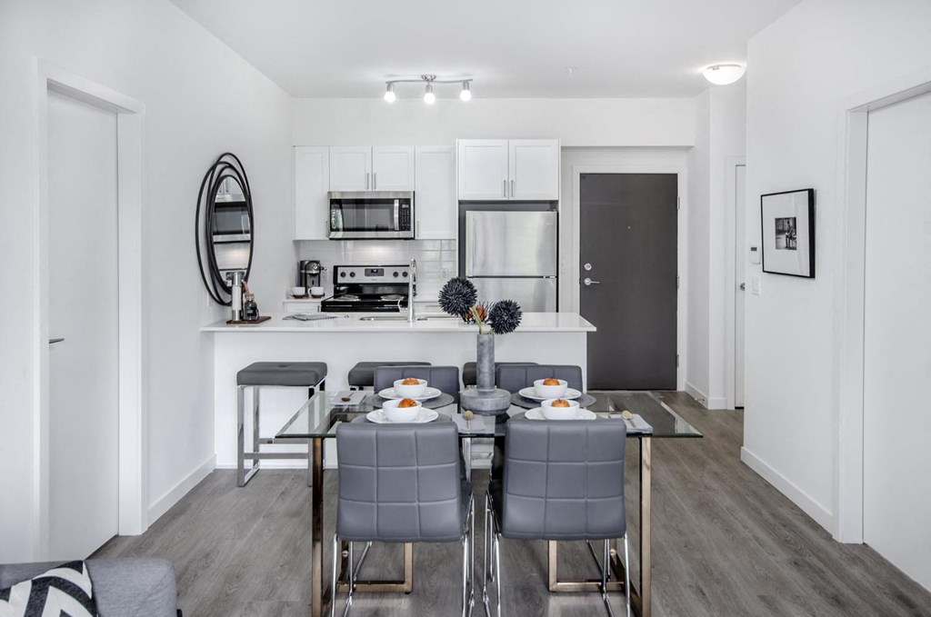an open kitchen and dining area with a table and chairs