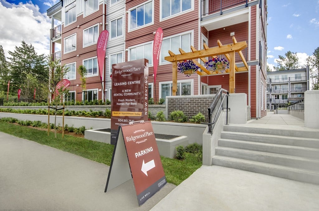 a rendering of a building with signs in front of it