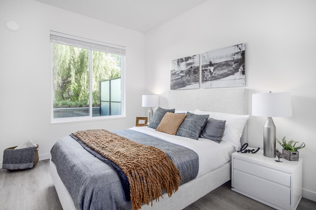 a bedroom with a large bed and a window