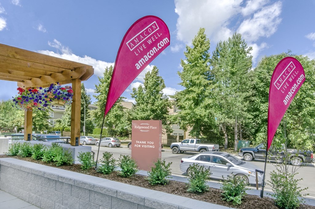 a parking lot with pink signs in front of a building