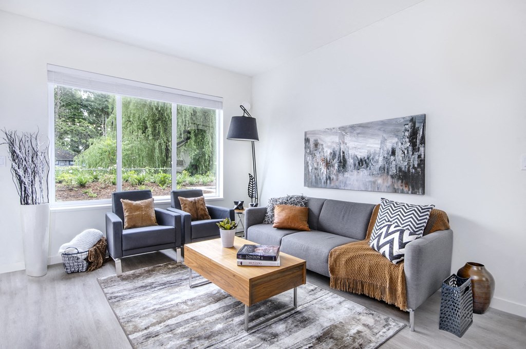 a living room with a gray couch and a coffee table