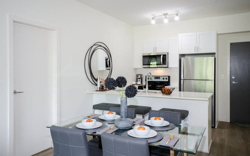 a kitchen and dining room with a table and chairs