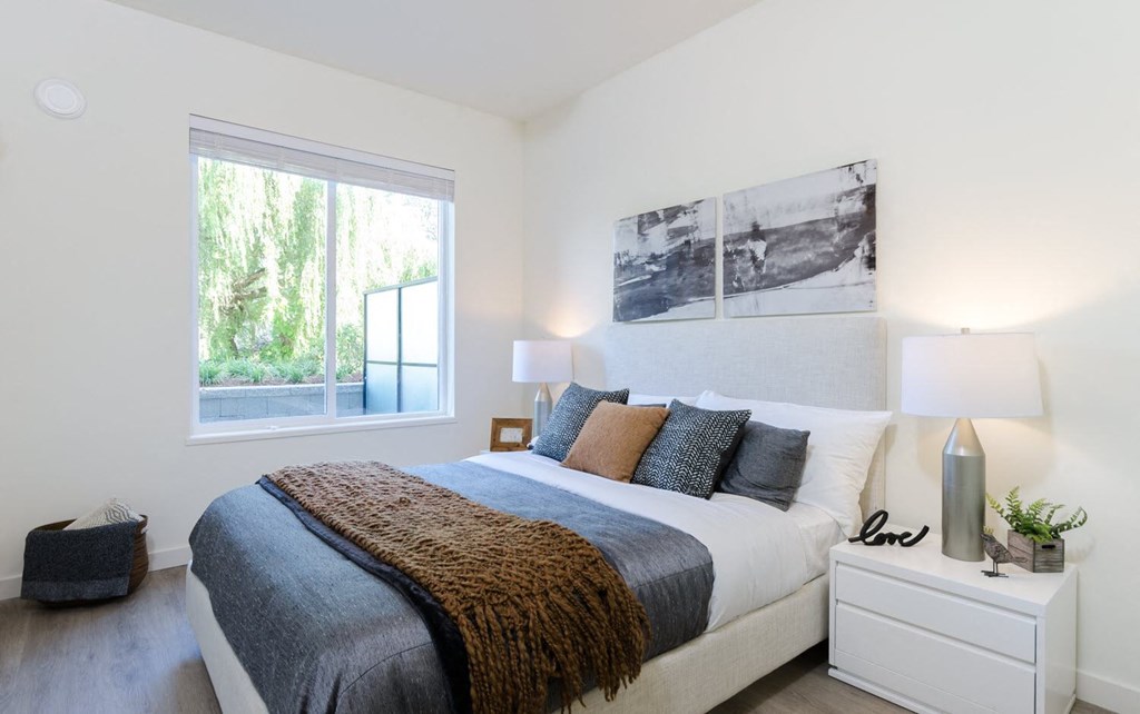 a bedroom with a bed and a window