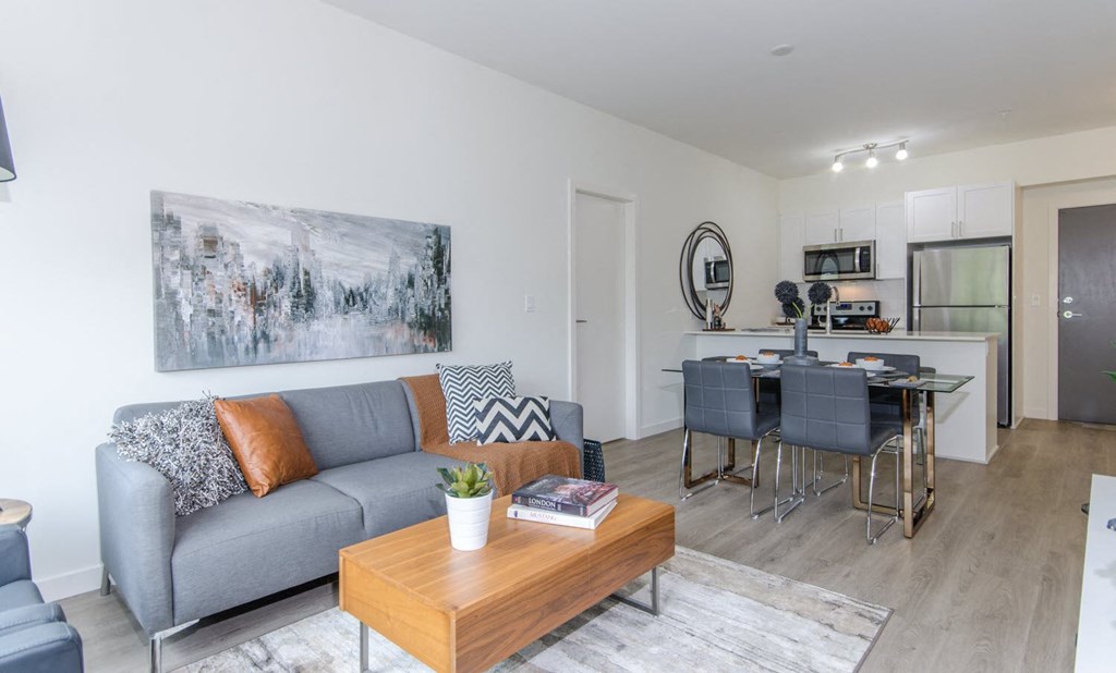 a living room with a couch and a table and a kitchen