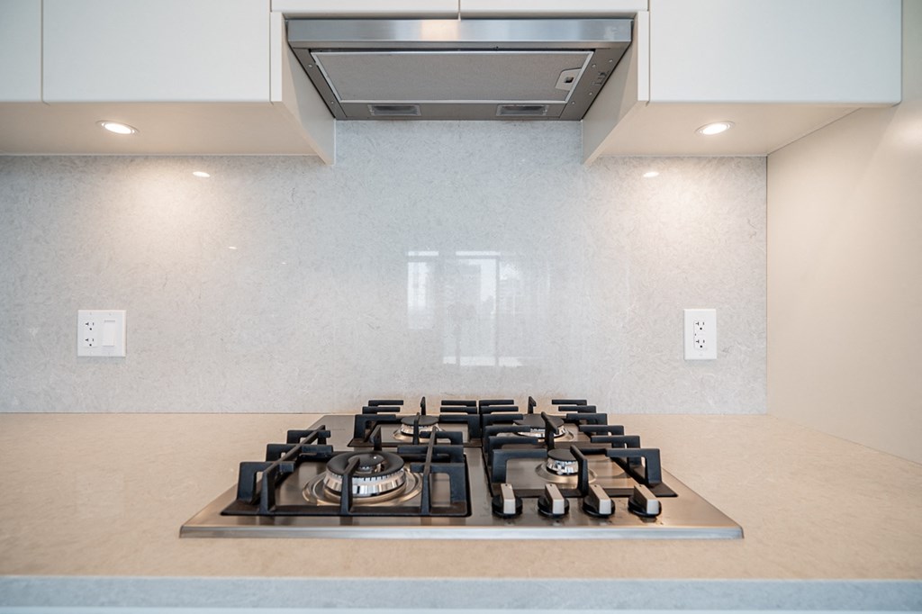a kitchen with a stove top oven and a counter top