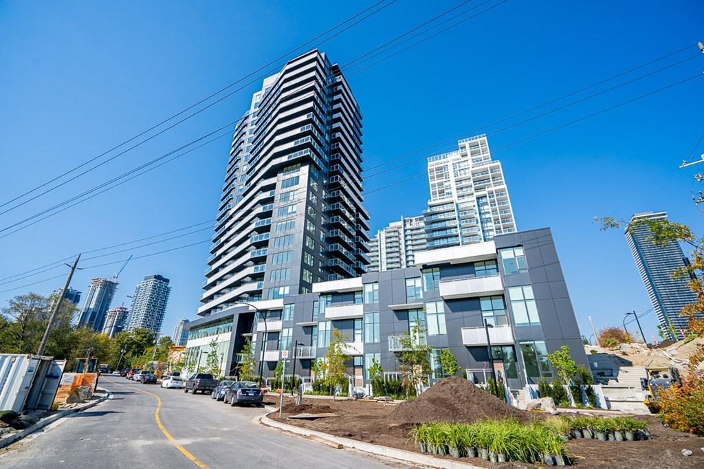 a view of an apartment building in front of a city street