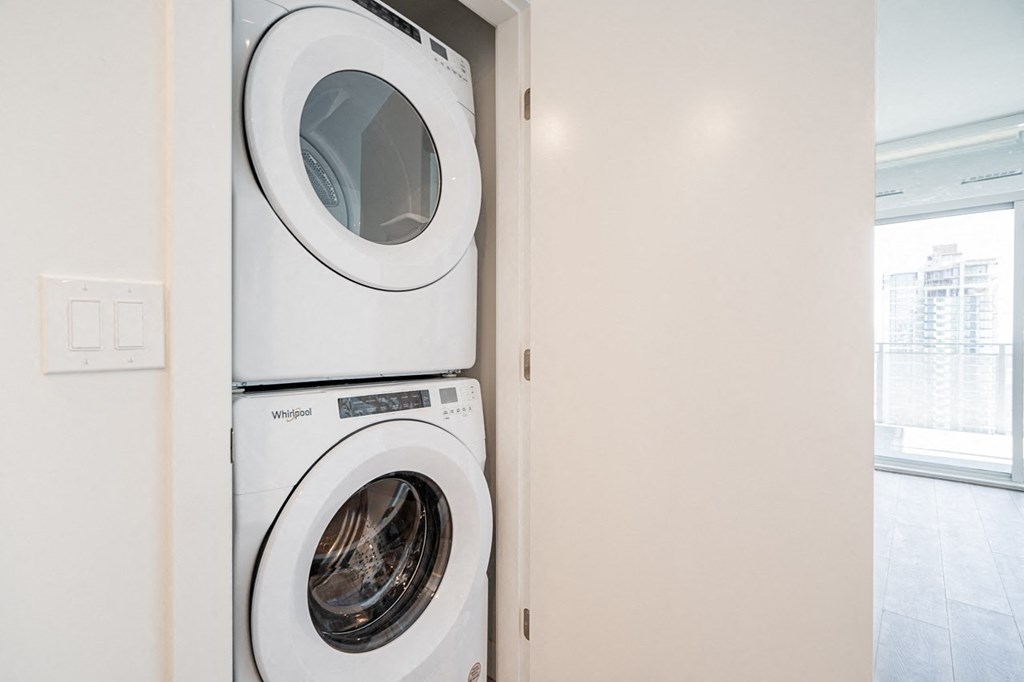 a white washer and dryer in a white closet