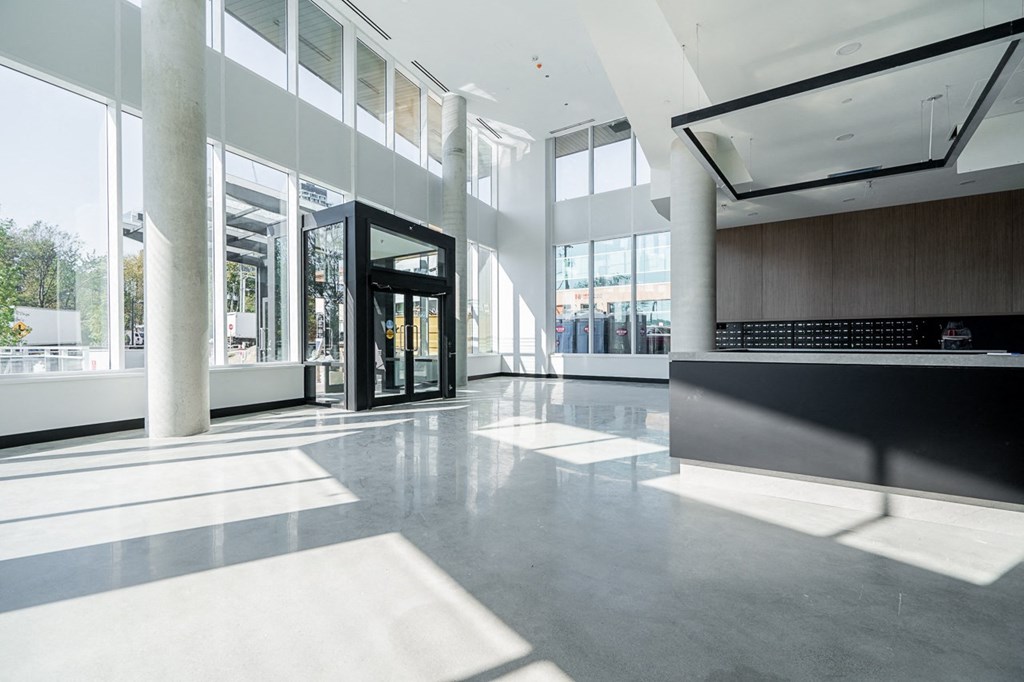 the lobby of a large office building with a door and windows
