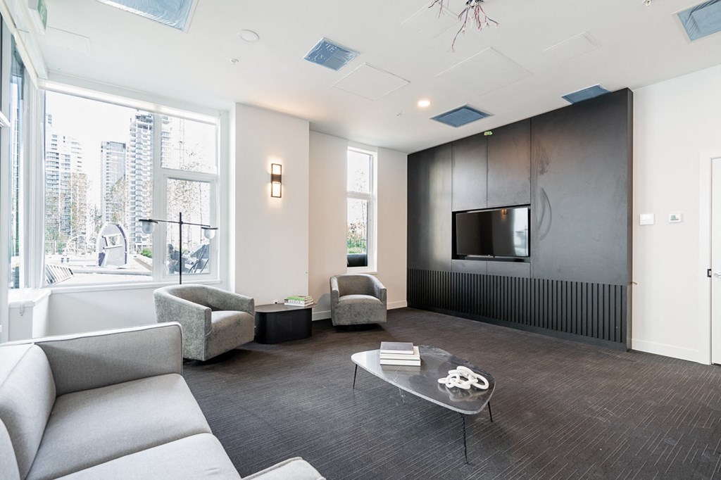 a living room with a couch and a coffee table and a television