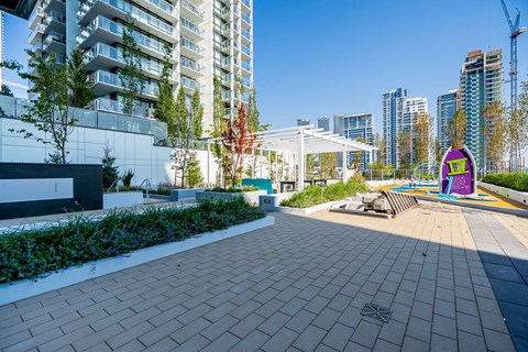 a park with a playground and buildings in the background