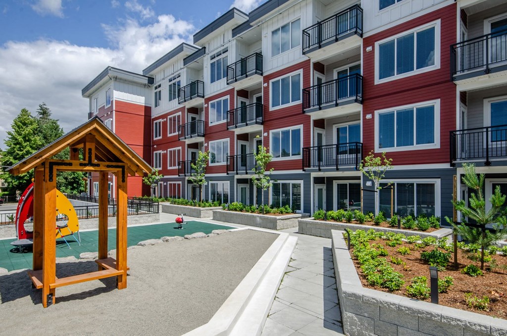a courtyard with a playground in front of an apartment building