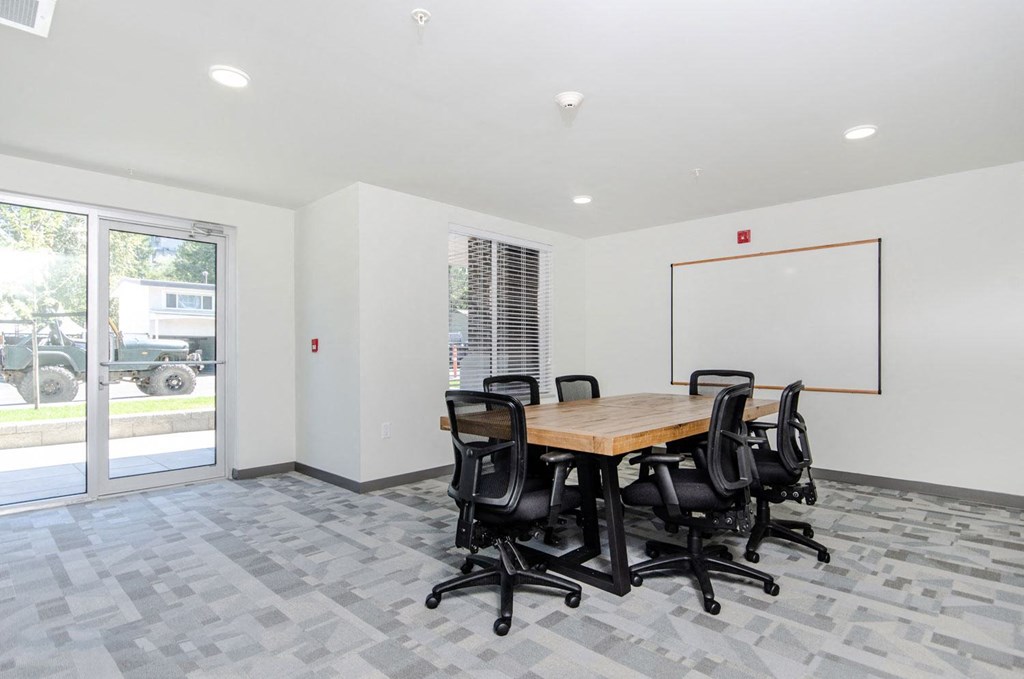a conference room with a wooden table and chairs