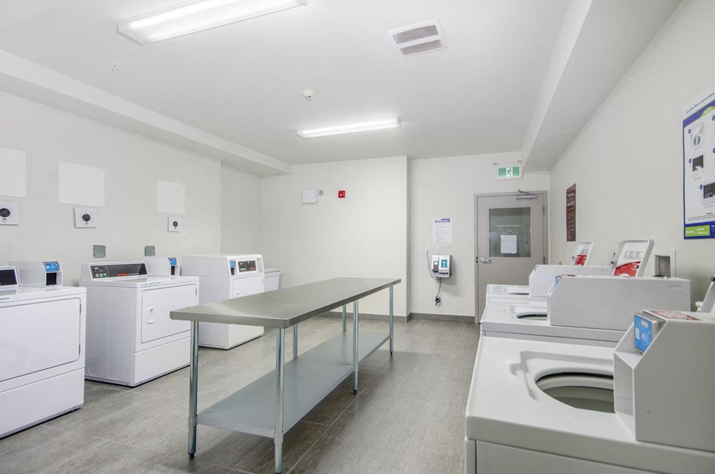 a laundry room with washing machines and a table