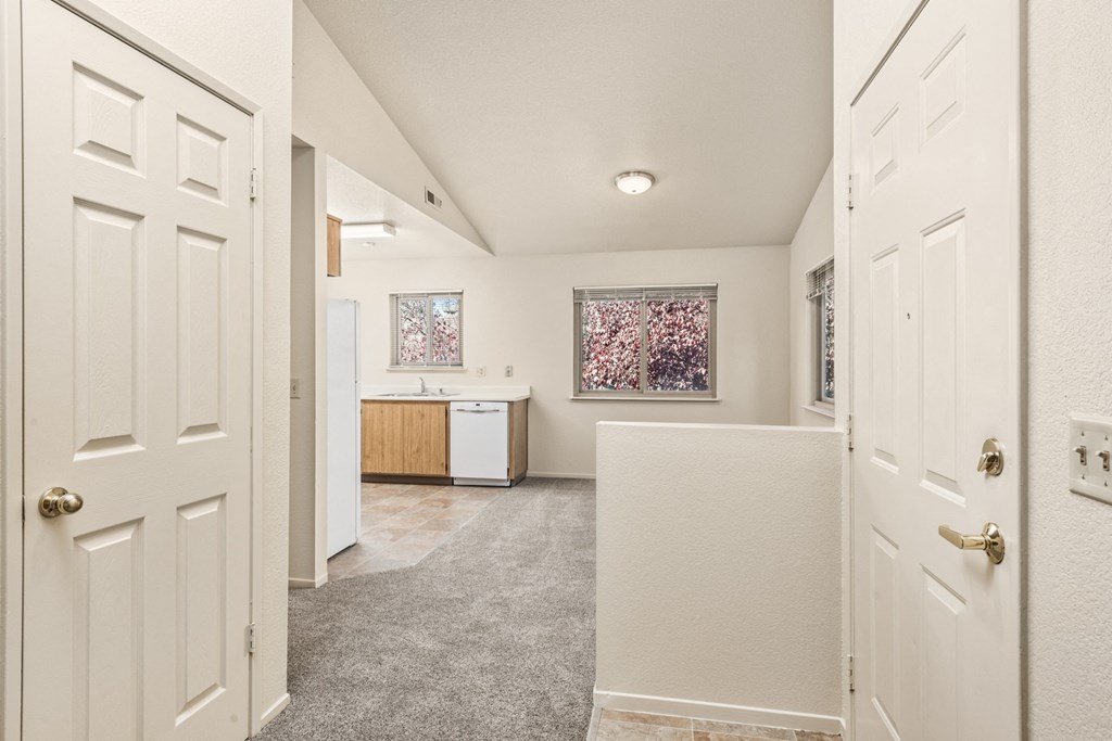 Hallway with white doors and a kitchen at Meadowview Apartments, Santa Rosa, CA