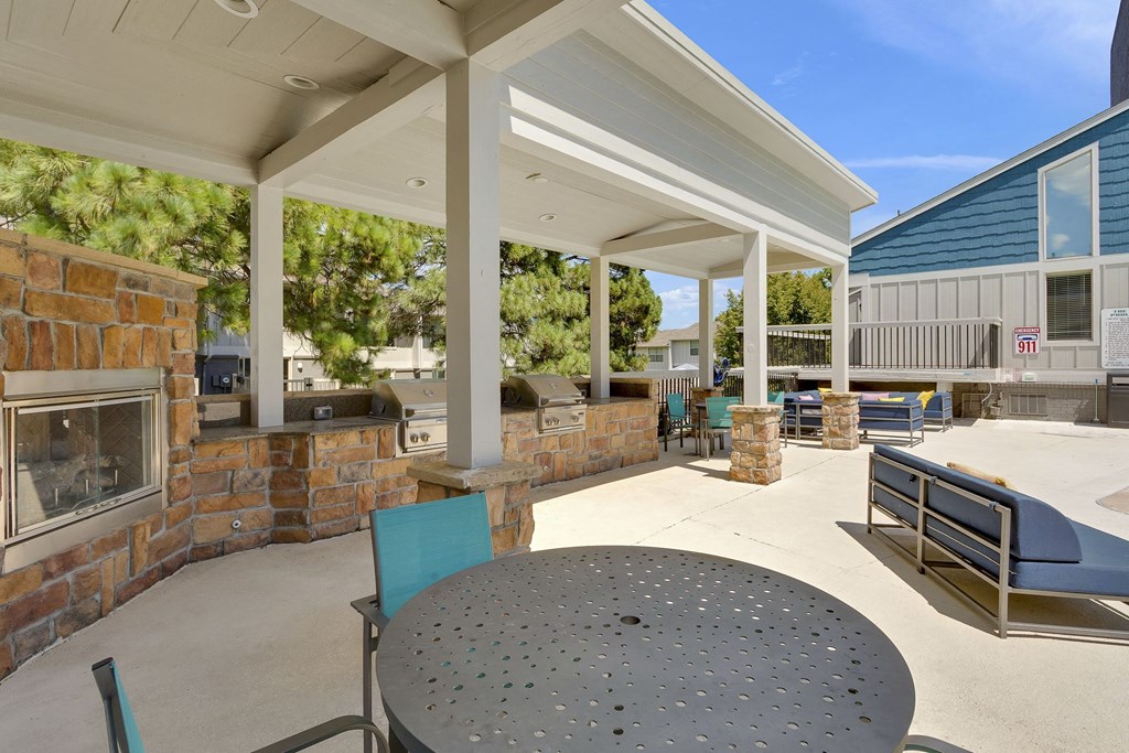 Outdoor bbq and fireplace with lounge chair seating