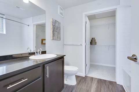 A bathroom with a white sink and toilet.