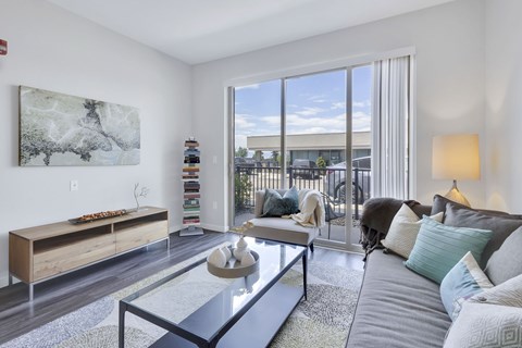 A living room with a grey couch and a coffee table.