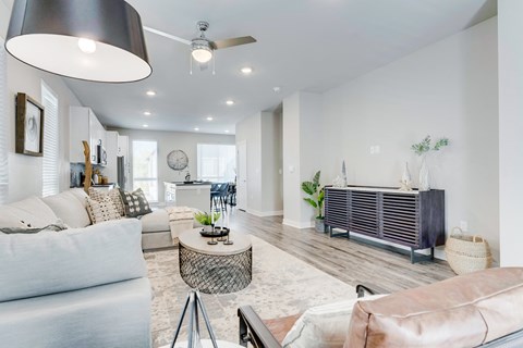 Living room with large plush couch, dining table and tv stand