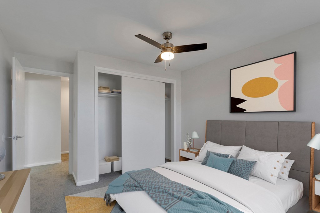 bedroom with large bed and view of closet and door entry