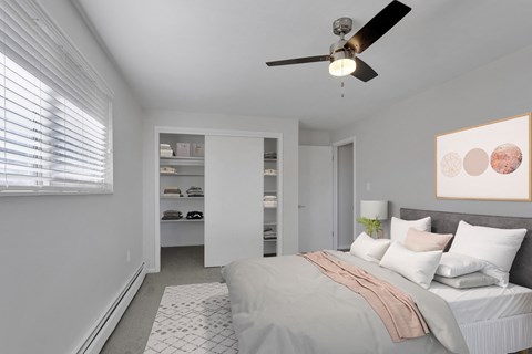 a bedroom with a large bed and a ceiling fan