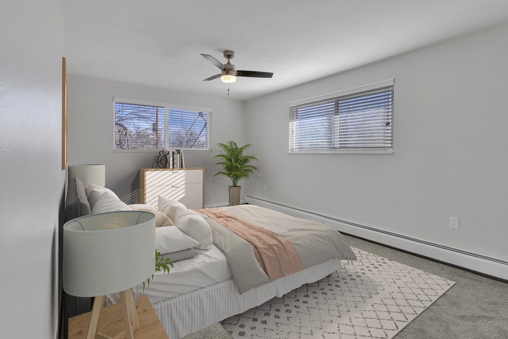 bedroom with two windows and ceiling fan