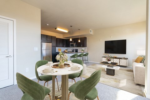 A modern dining room with a round table set for four.